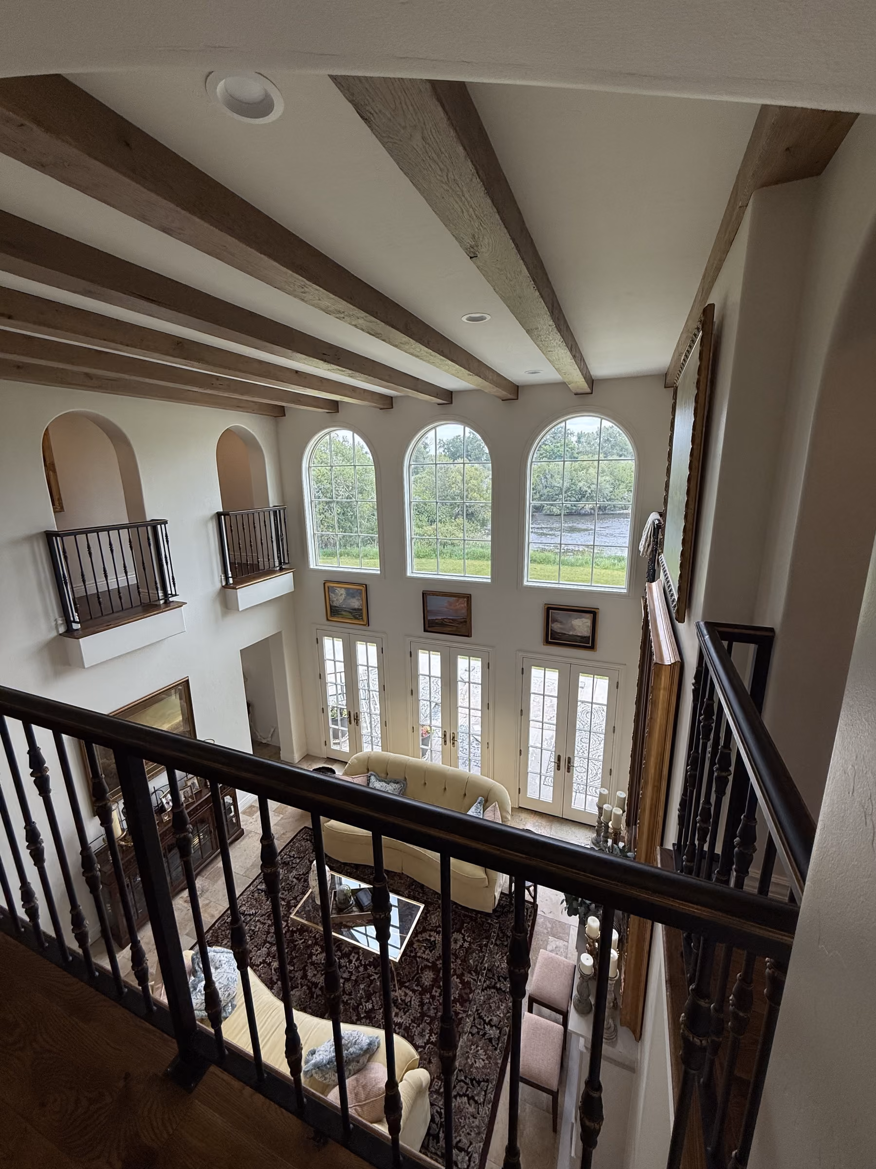 Cleaning two-story arched windows in a Teton Valley mountain home