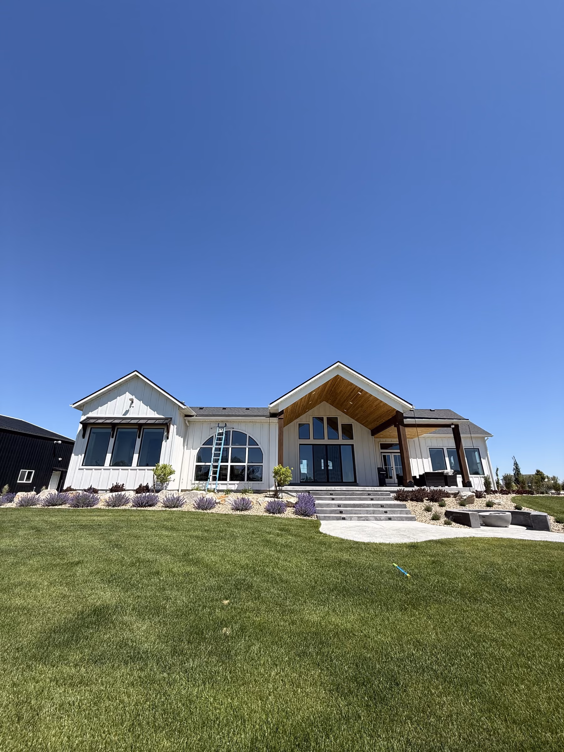 Newly built modern farmhouse with large, clean windows in Southeast Idaho
