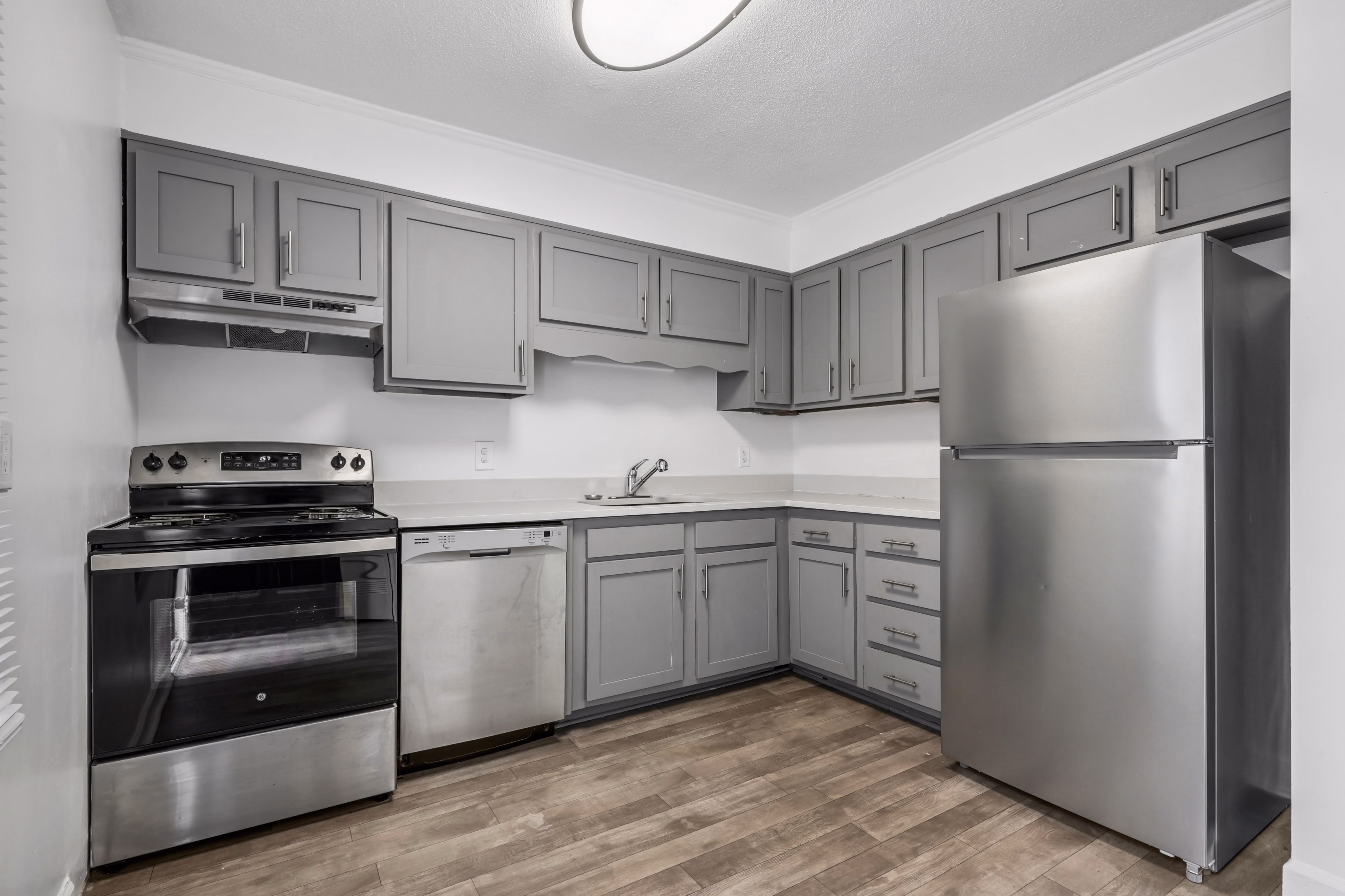 Kitchen with dark gray cabinets and stainless steel appliances
