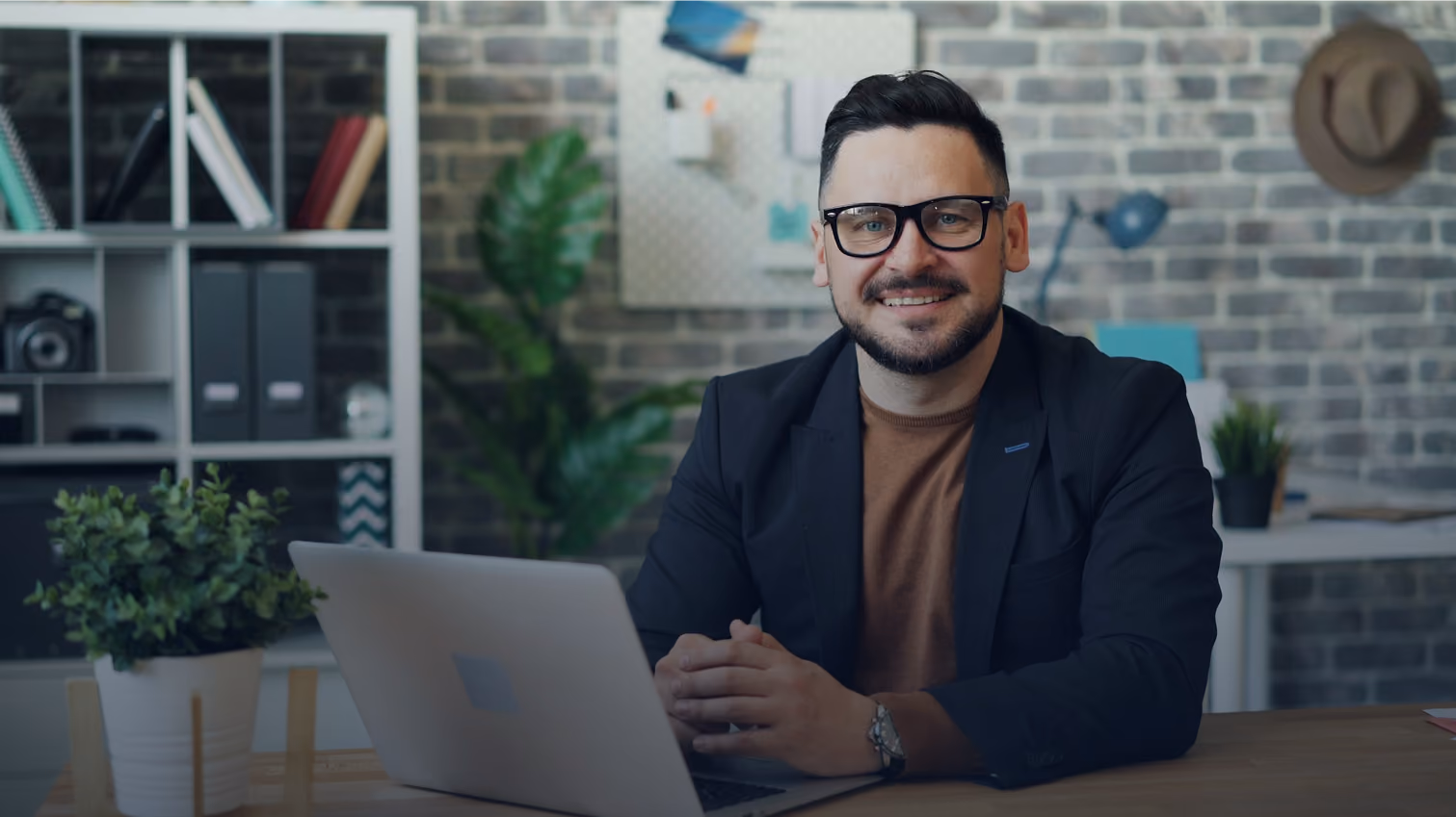 A single director at his desk, working on a laptop