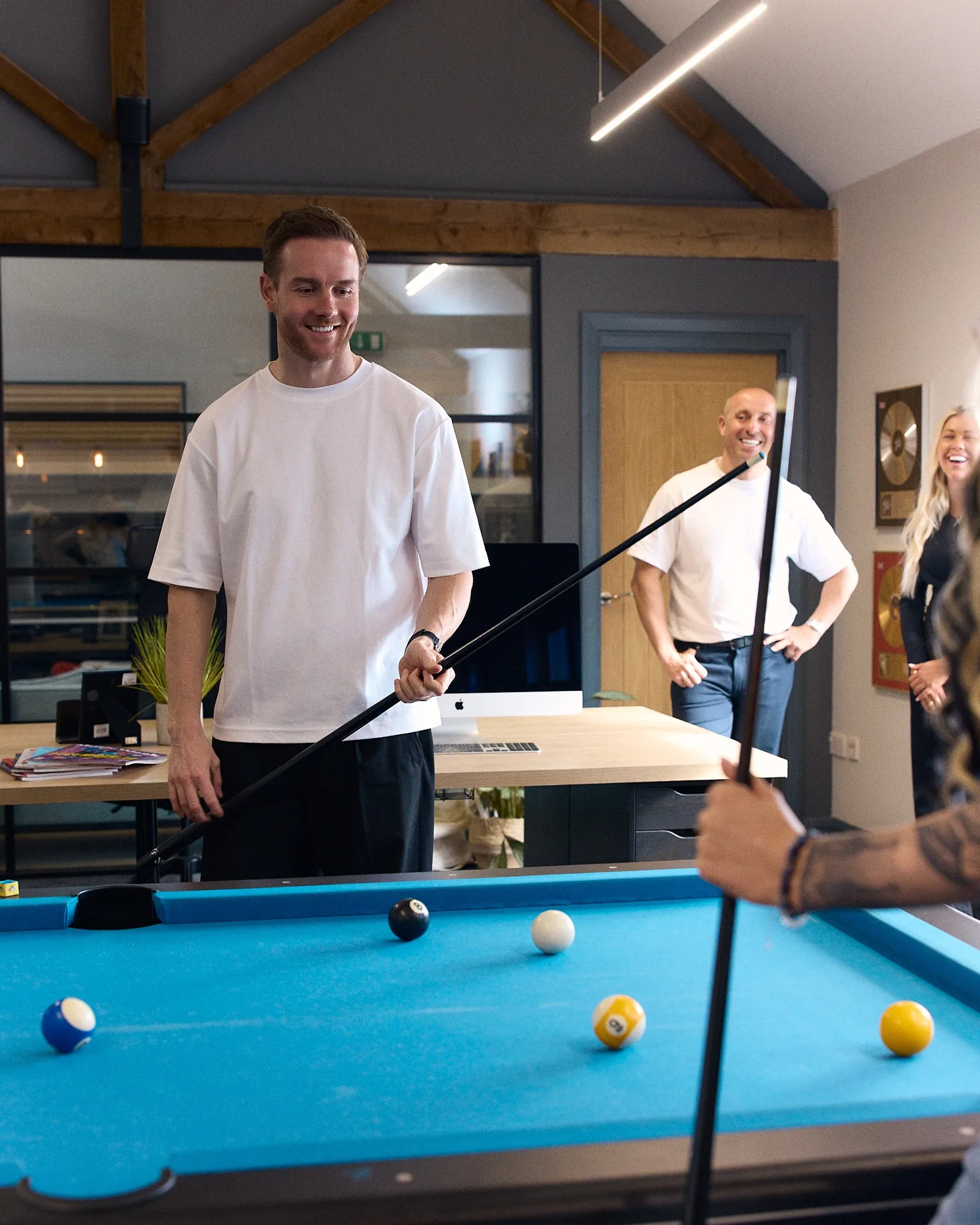 Team photo and lawrence and alex playing pool with the team