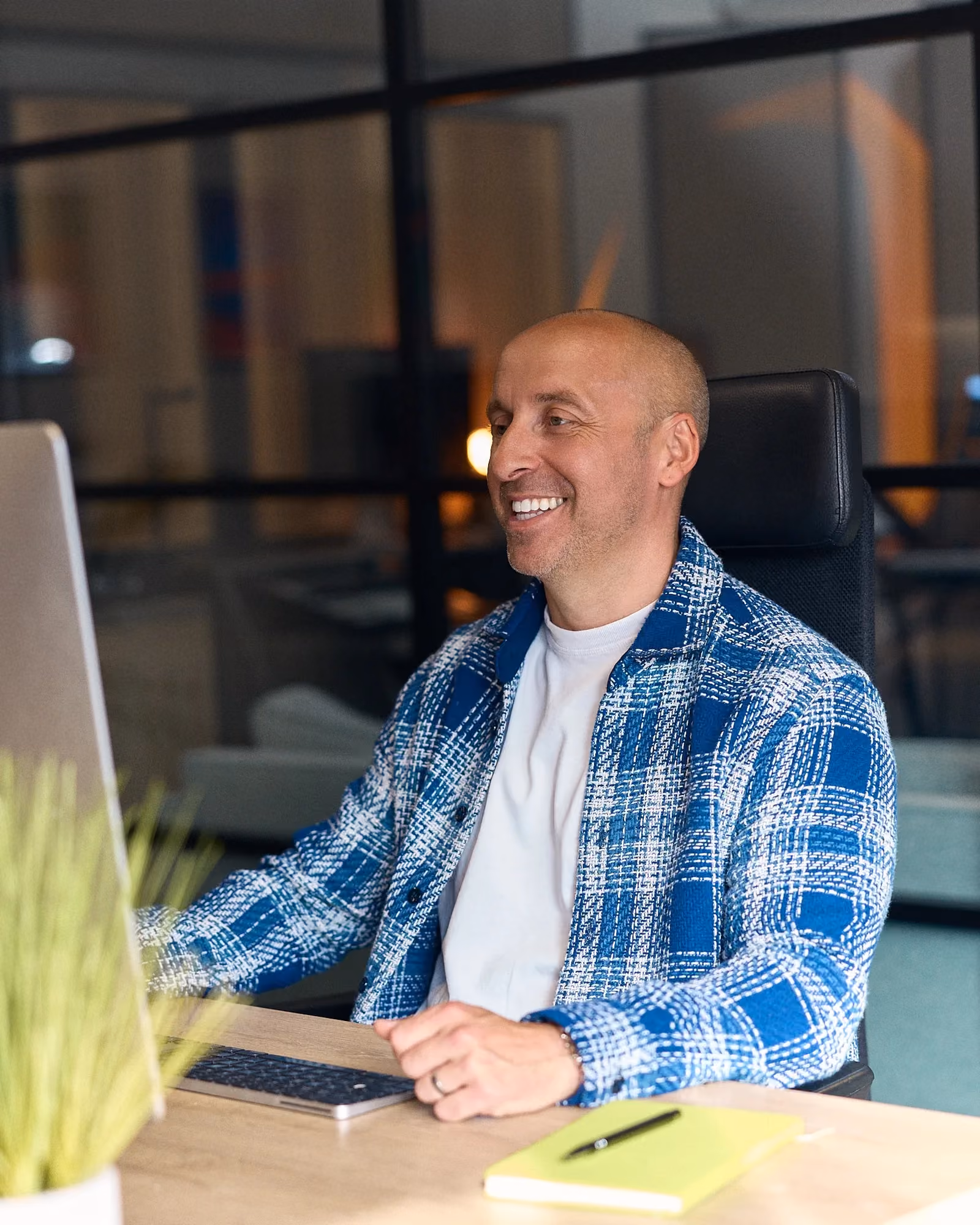 alex ogden sat at his desk talking to a client online about relevant life insurance