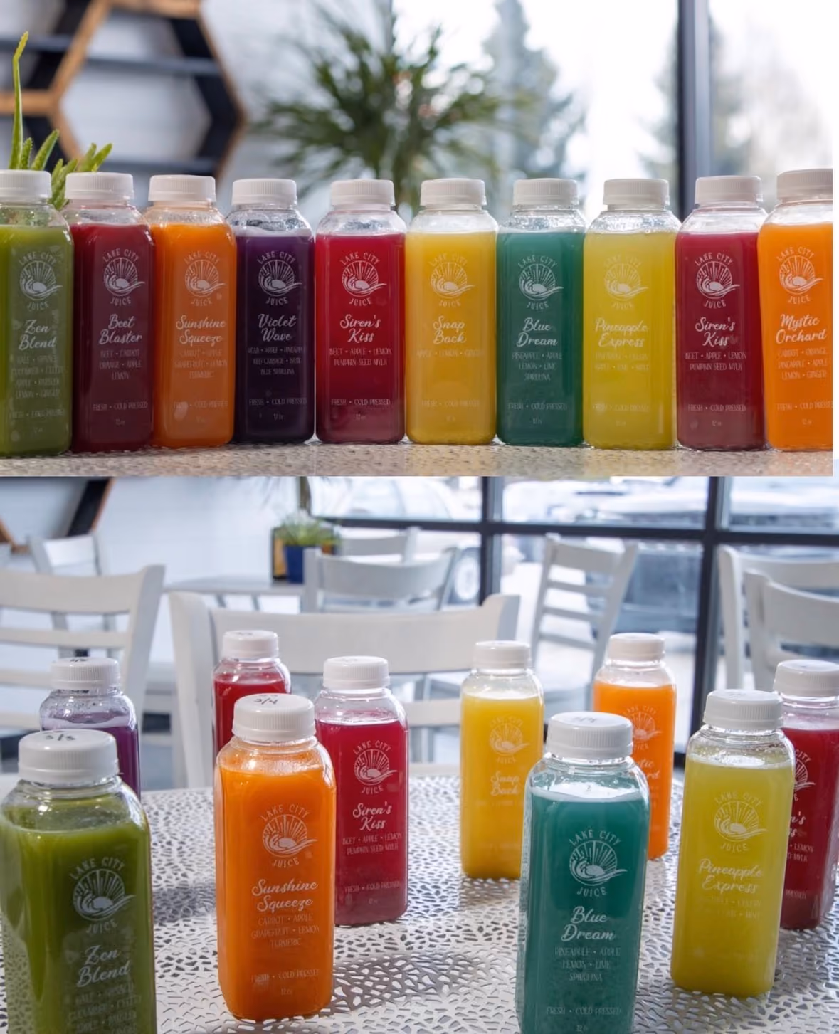 Rows of colorful cold-pressed juice bottles with various flavors on a table and countertop indoors.