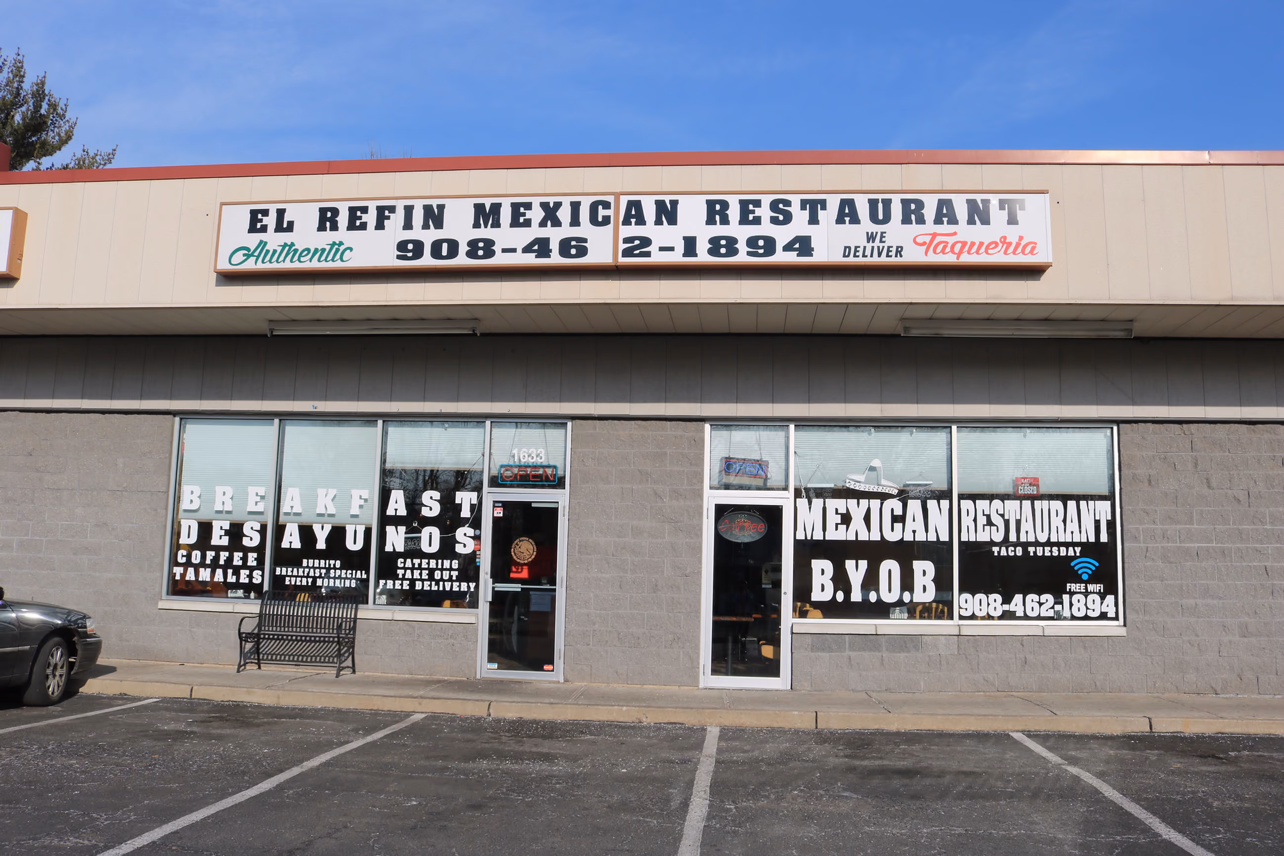 Front of El Refin Mexican Restaurant with signs advertising breakfast, tamales, and taco Tuesday specials.