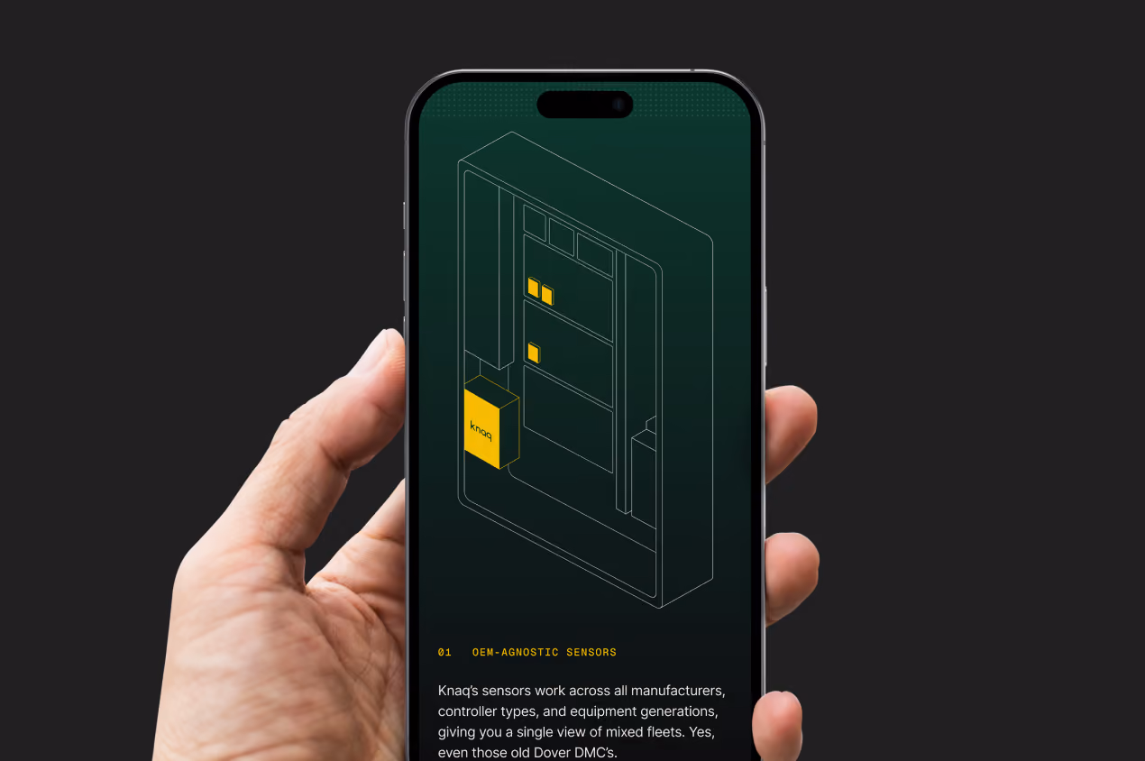 Hand holding a phone showing a Knaq diagram of elevator equipment with yellow sensor highlights.