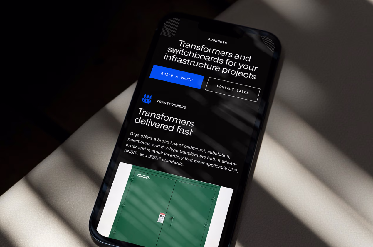 Giga mobile site on a phone in dramatic light, promoting transformers and switchboards with a green transformer photo.