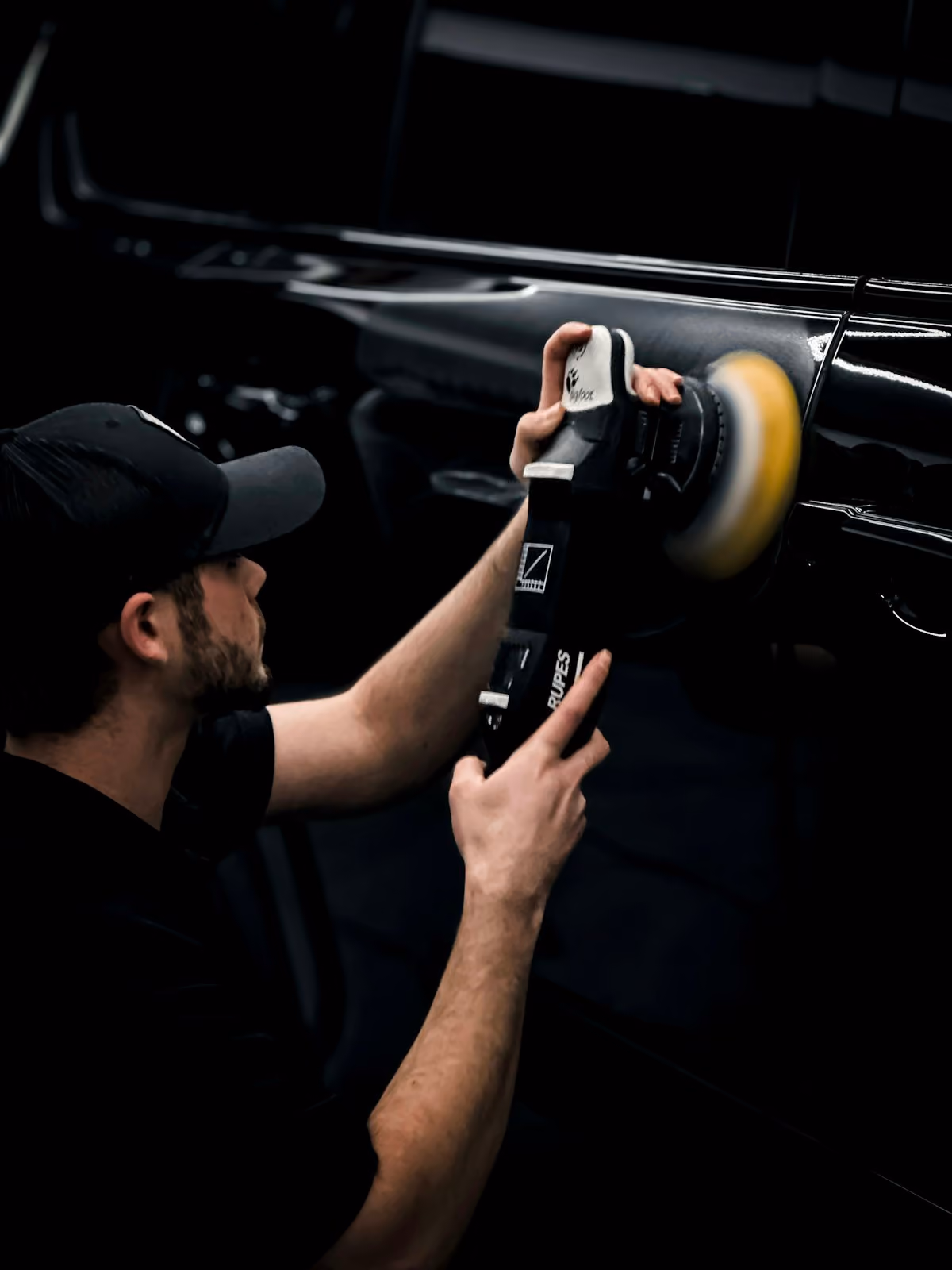 Detailer deep cleaning a vehicle interior
