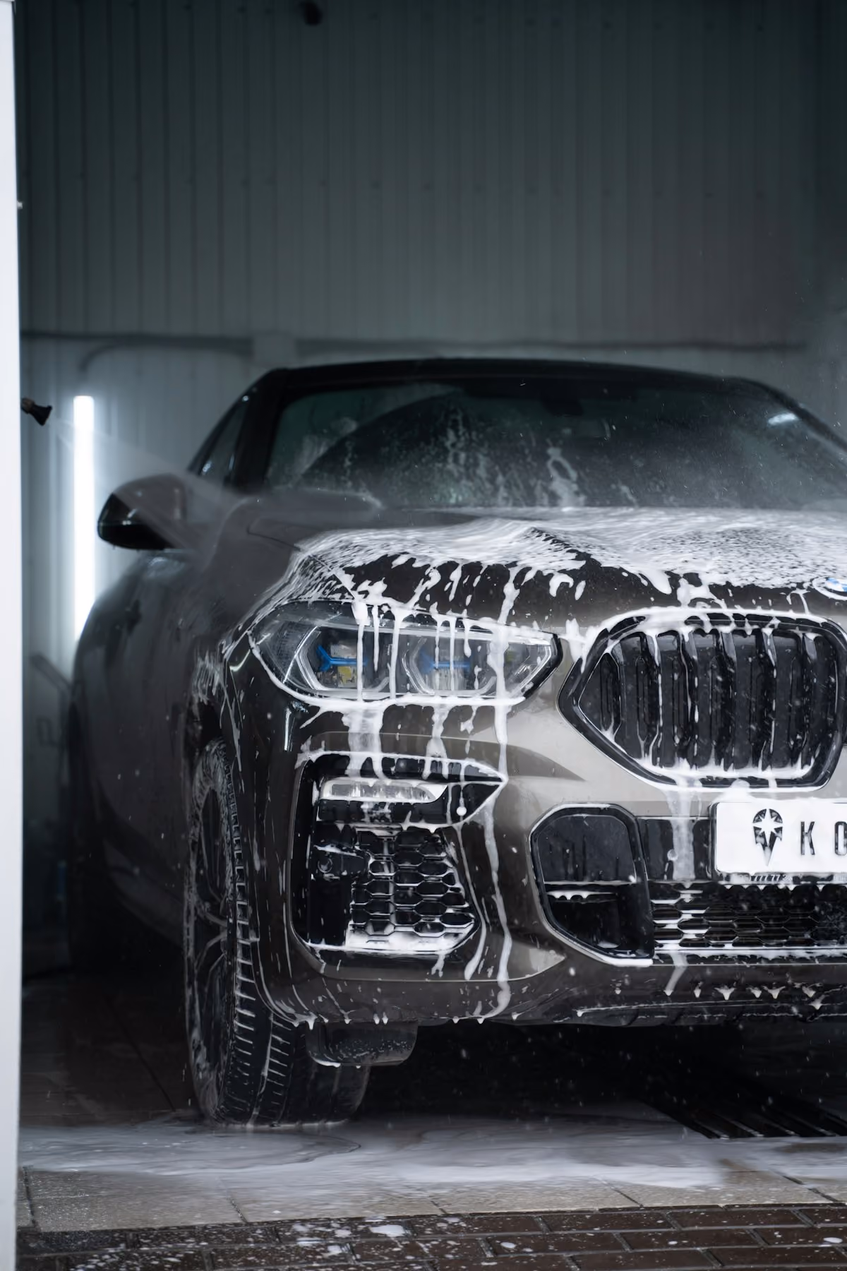 Car covered in foam during an exterior hand wash