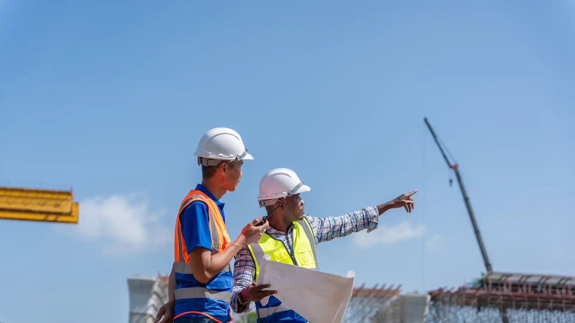 Construction professionals reviewing plans at a building site