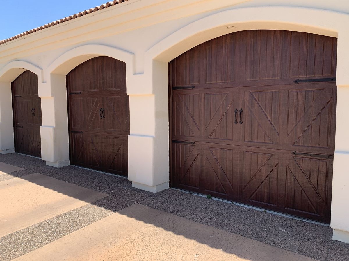 Two bay dark woodgrain carriage garage doors on an Arizona home