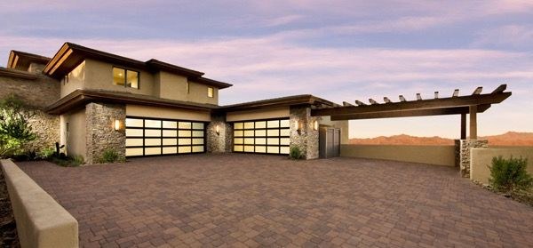 Newly installed garage doors lit at dusk