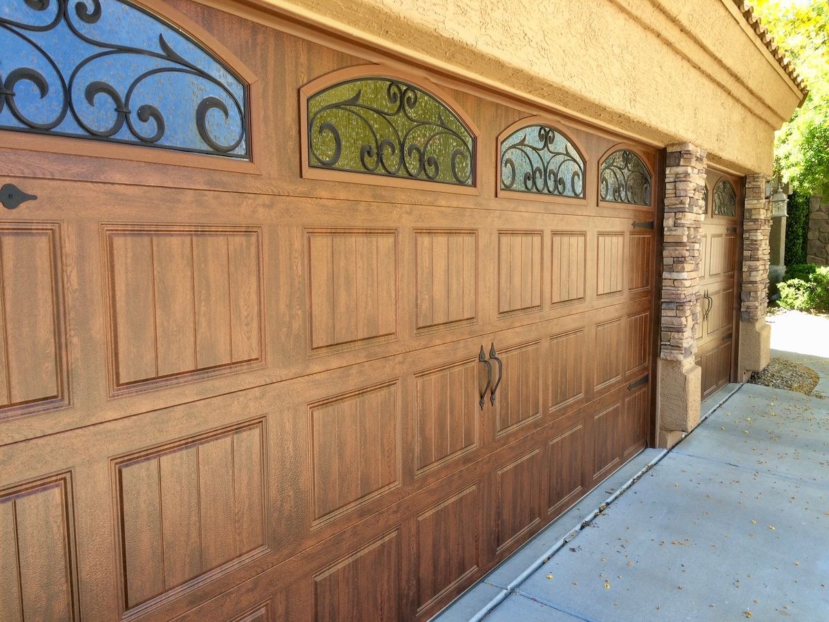 Wood garage door with decorative glass and ironwork