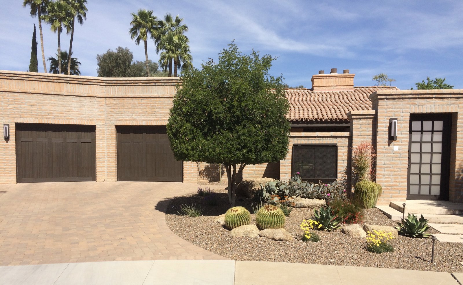 Two brown garage doors on a desert landscaped Arizona home