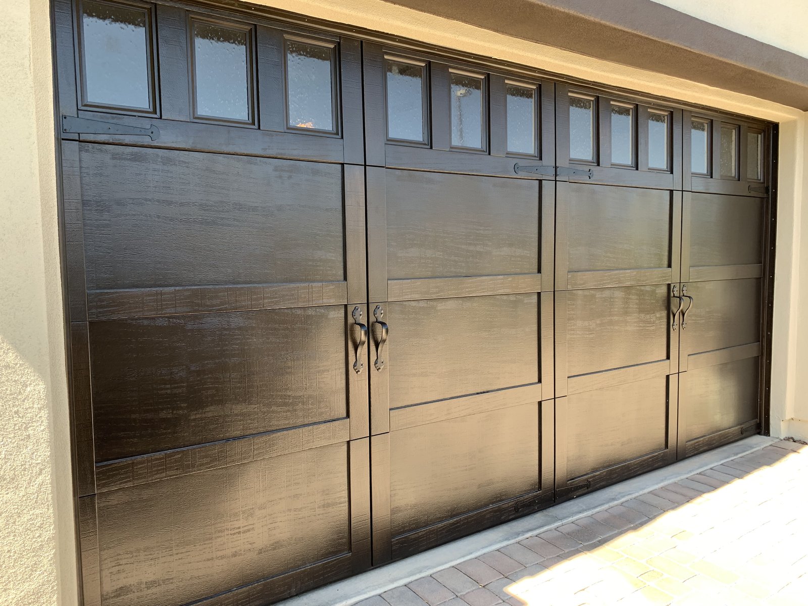 Woodgrain garage door with a full row of top windows