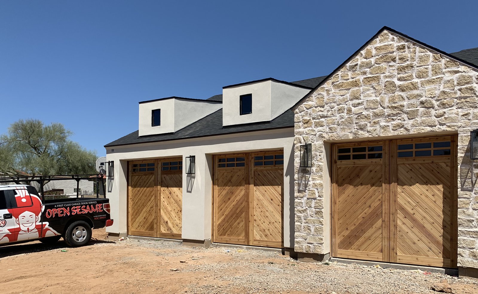 Two garage doors on a stone fronted Arizona home