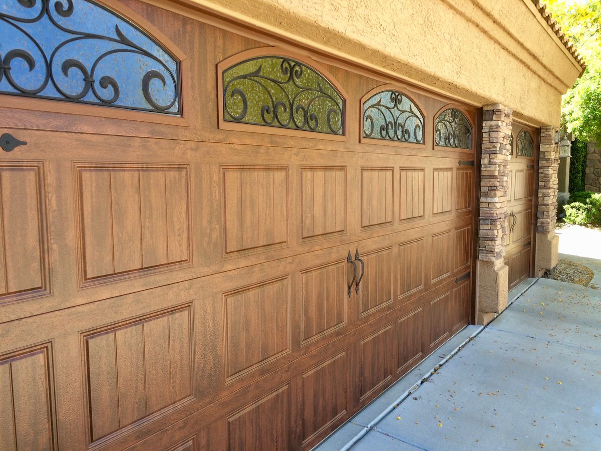 Wood garage door with decorative glass and ironwork
