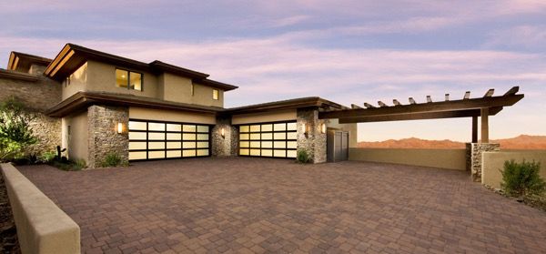 Newly installed garage doors lit at dusk