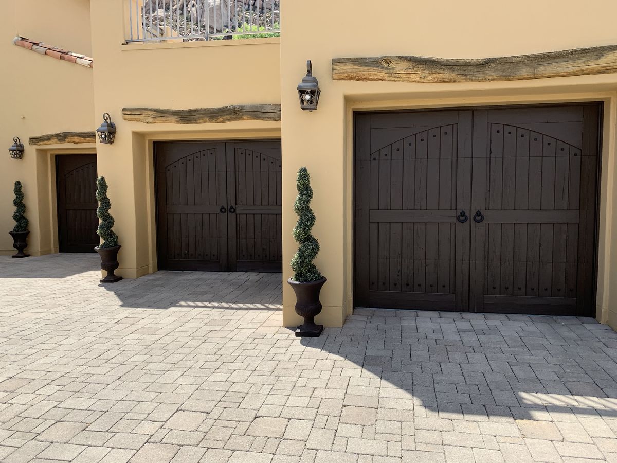 Replaced carriage style garage doors on a stucco home