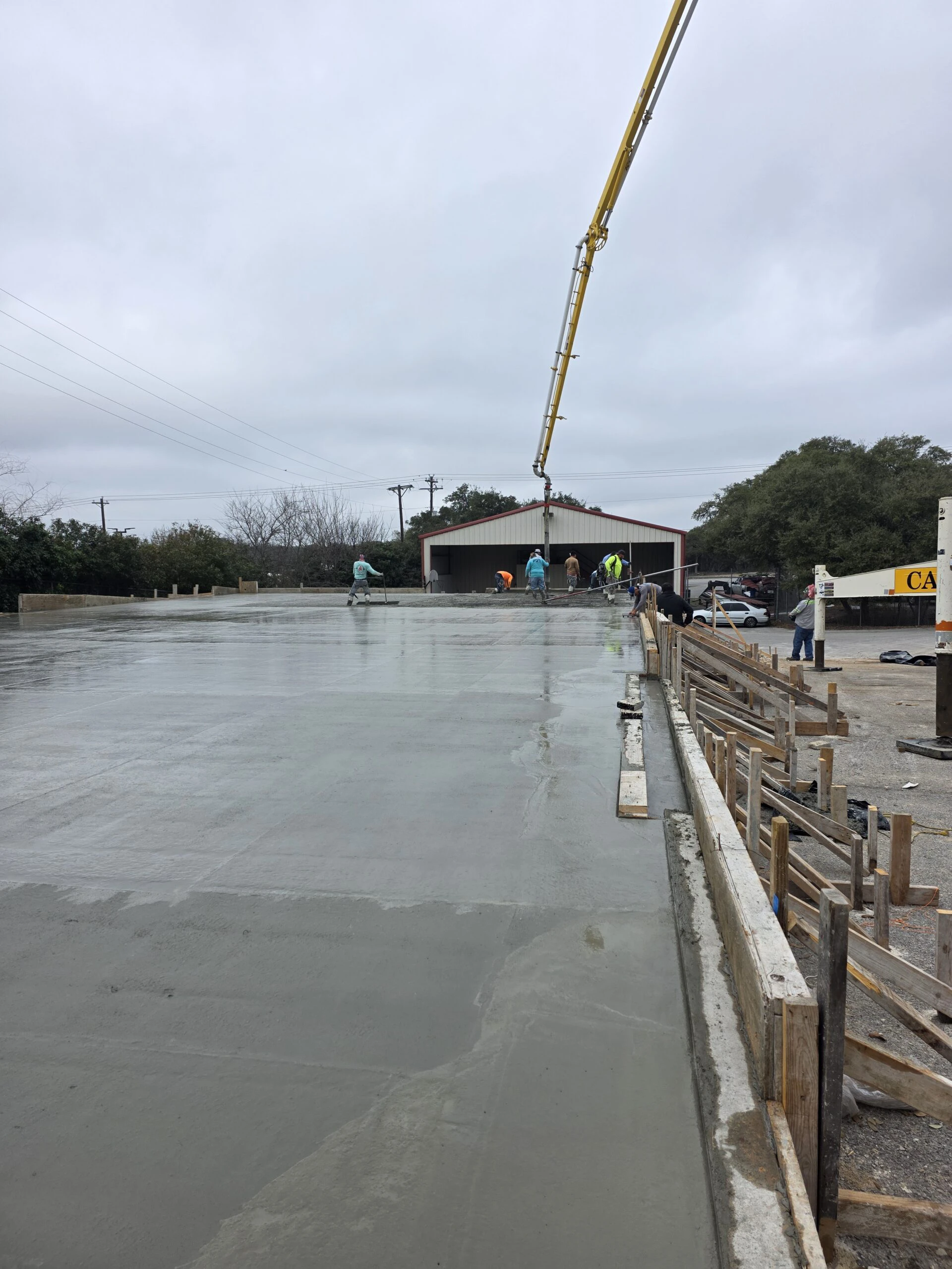 Concrete being placed by pump truck for the commercial slab