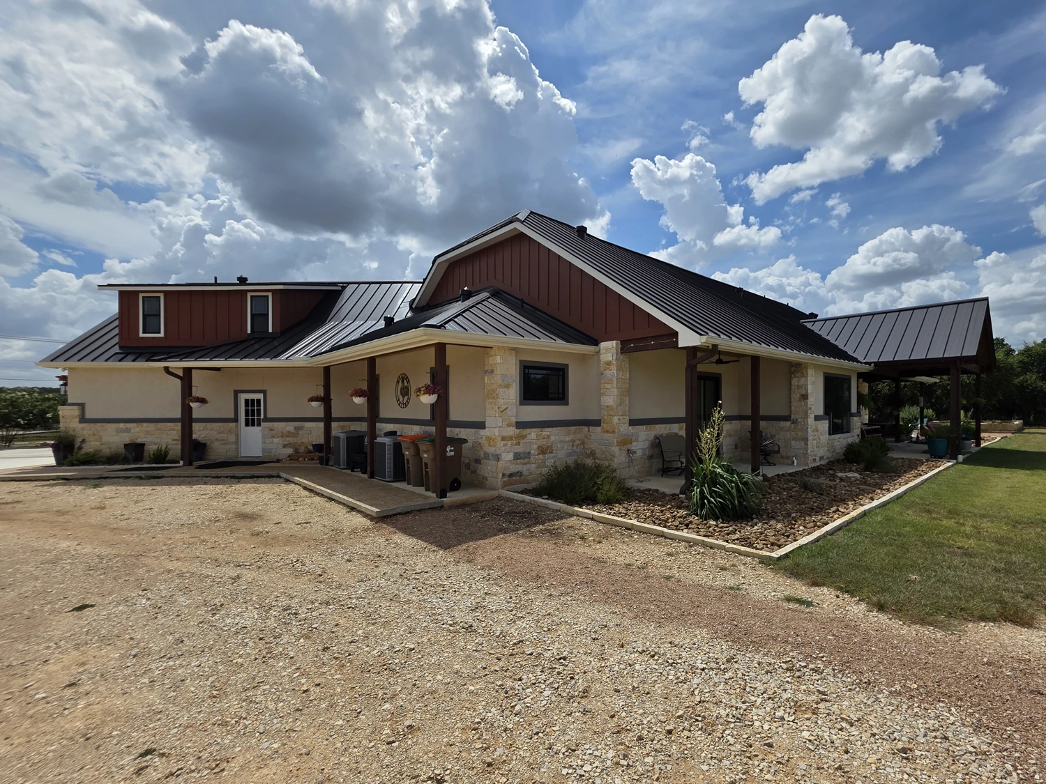 Side elevation of the custom home with a covered walkway and board-and-batten gables