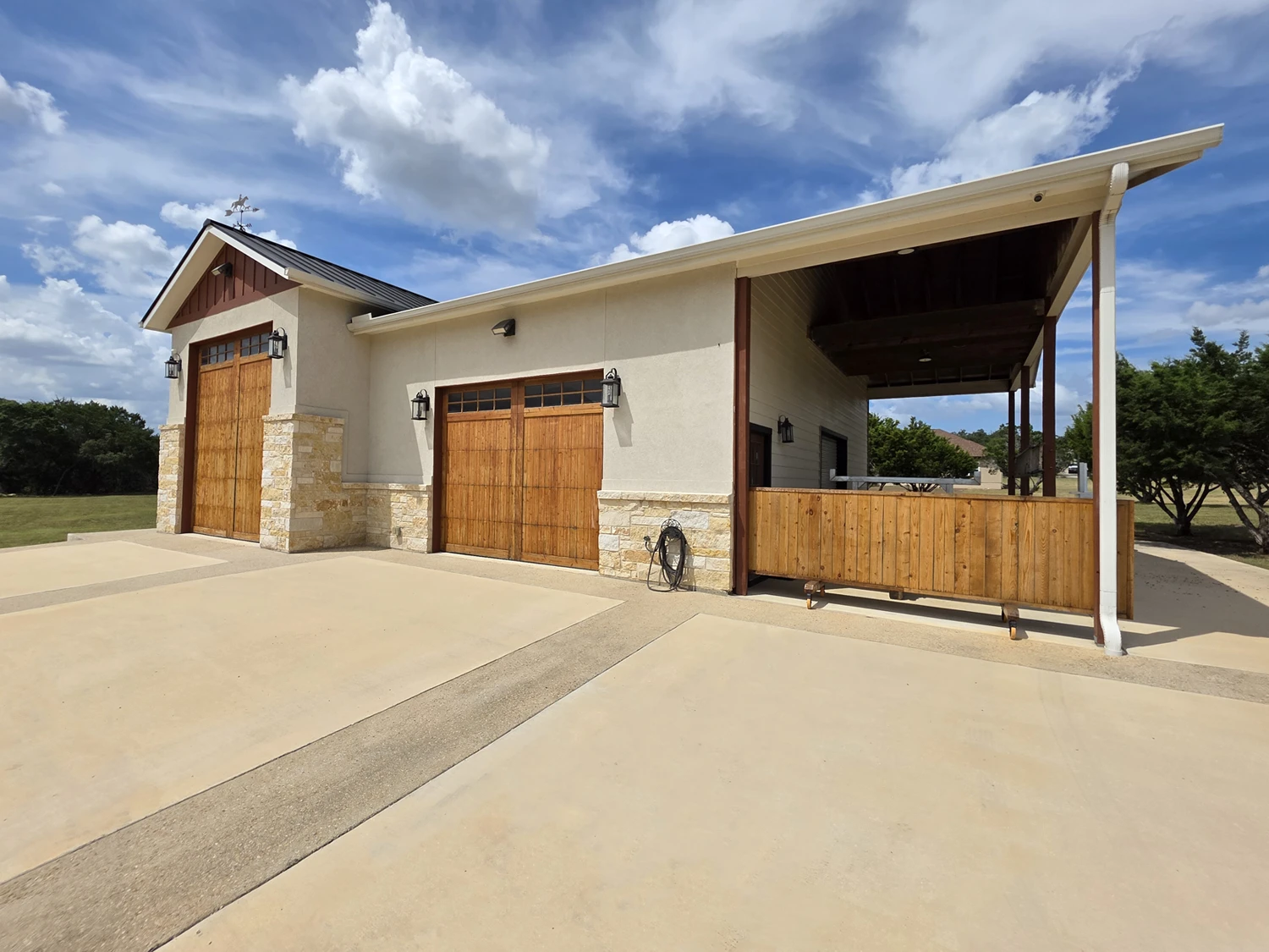 Detached RV garage and shop with cedar doors and a covered side bay