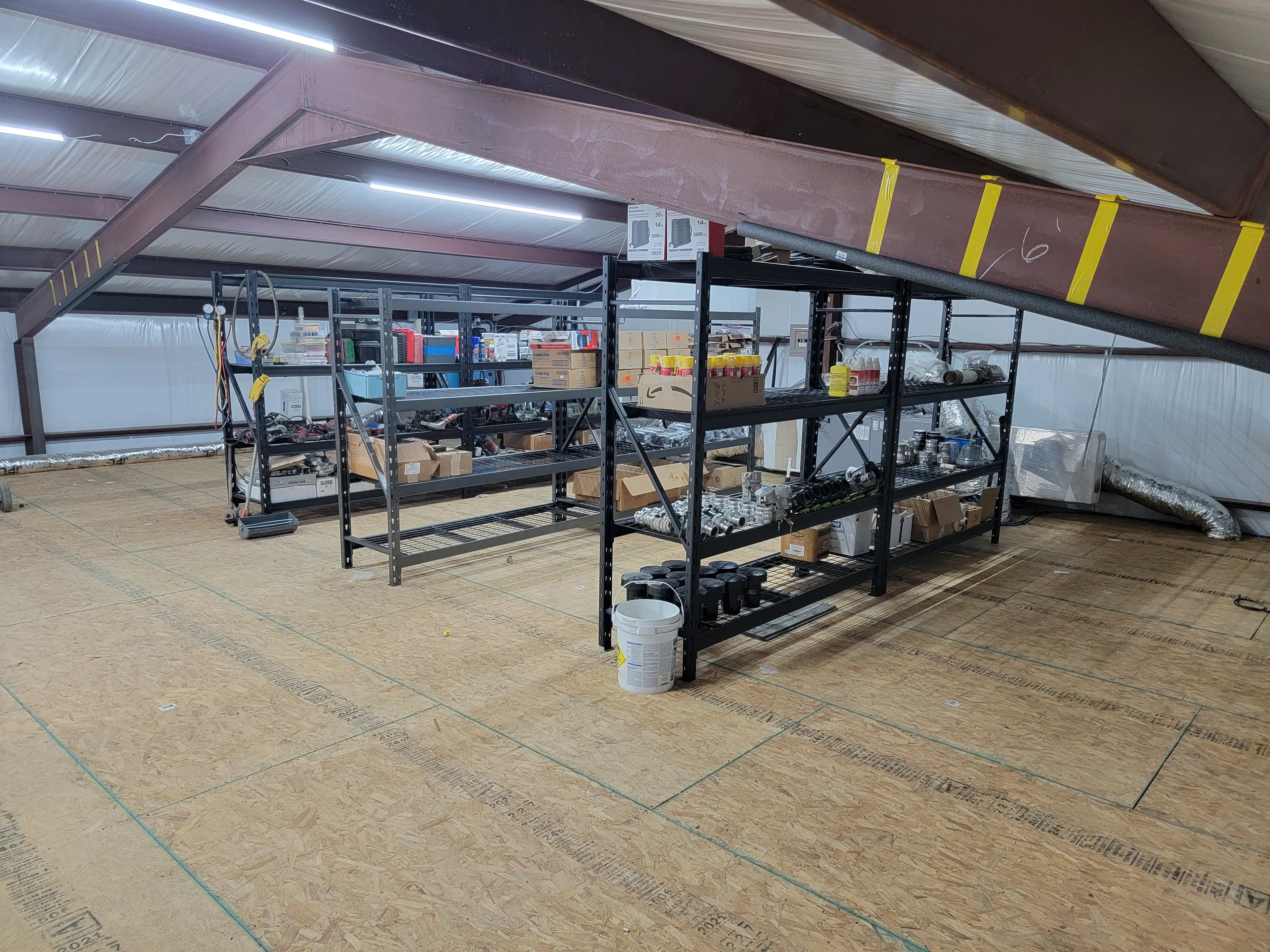 Mezzanine storage level with pallet racking stocked with parts above the shop floor