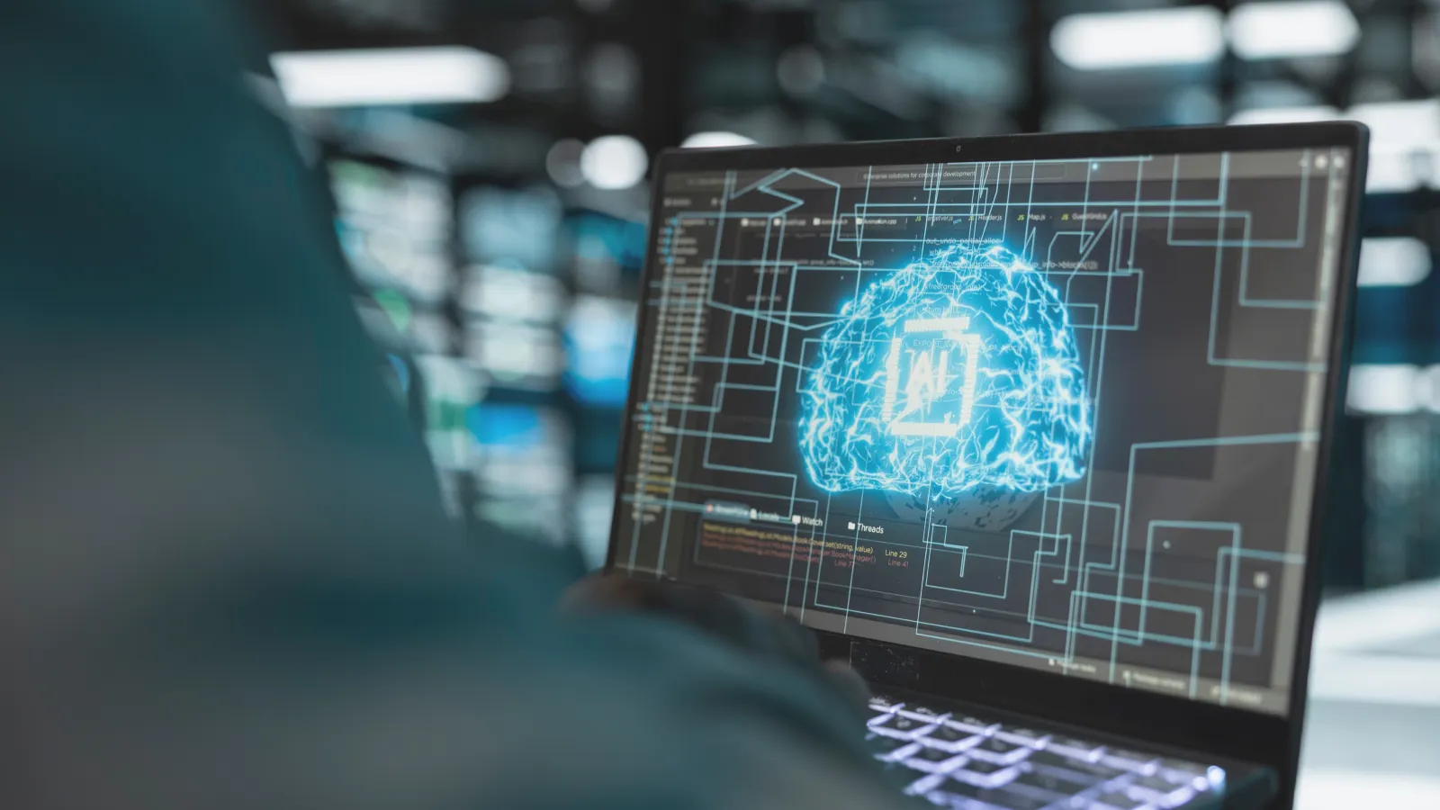 A developer viewing an AI model visualised as a glowing neural network on a laptop screen