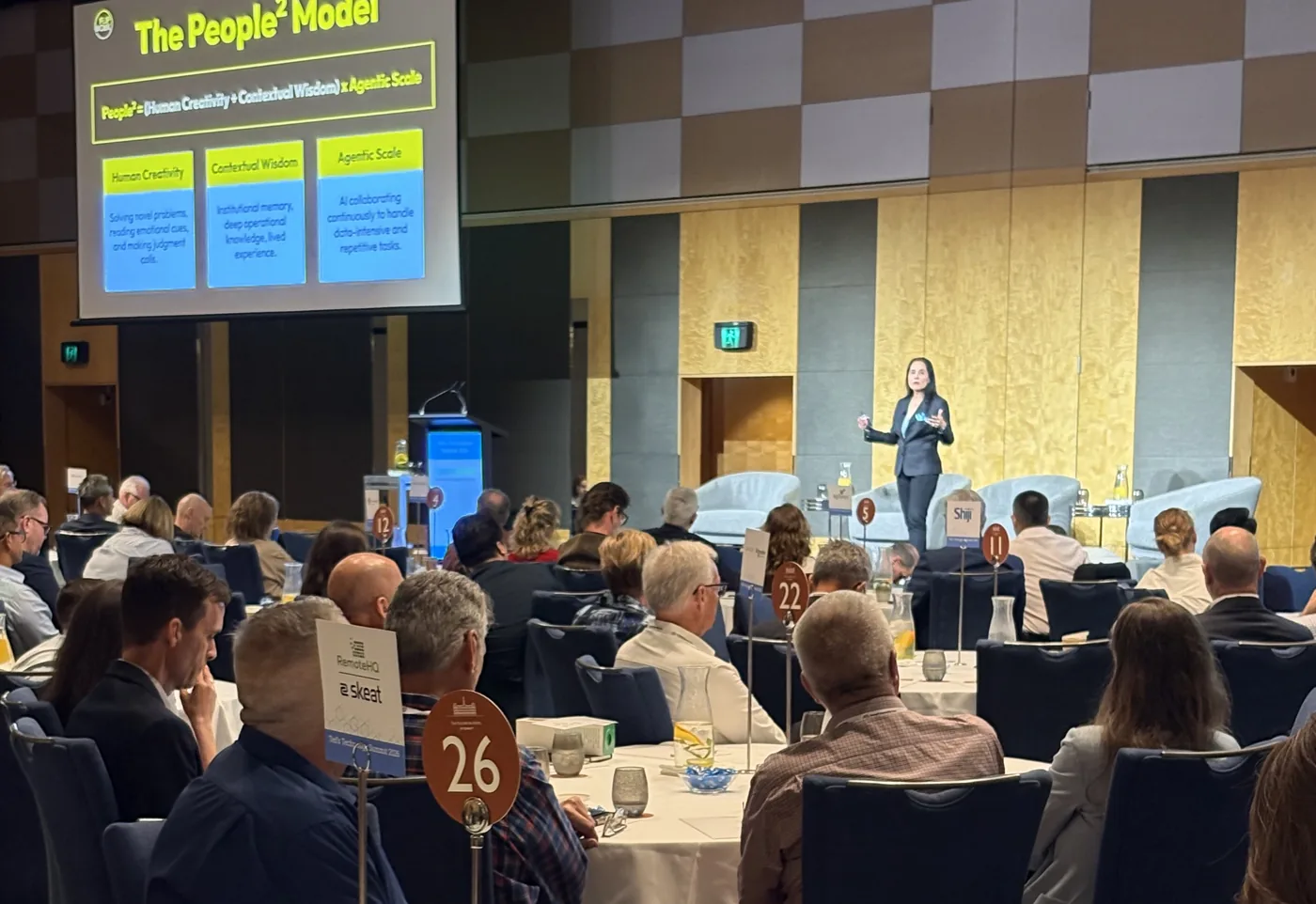 Nikki Barua presenting to a conference audience