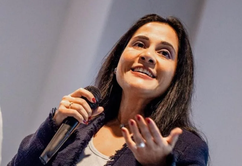 Nikki Barua speaking with a microphone
