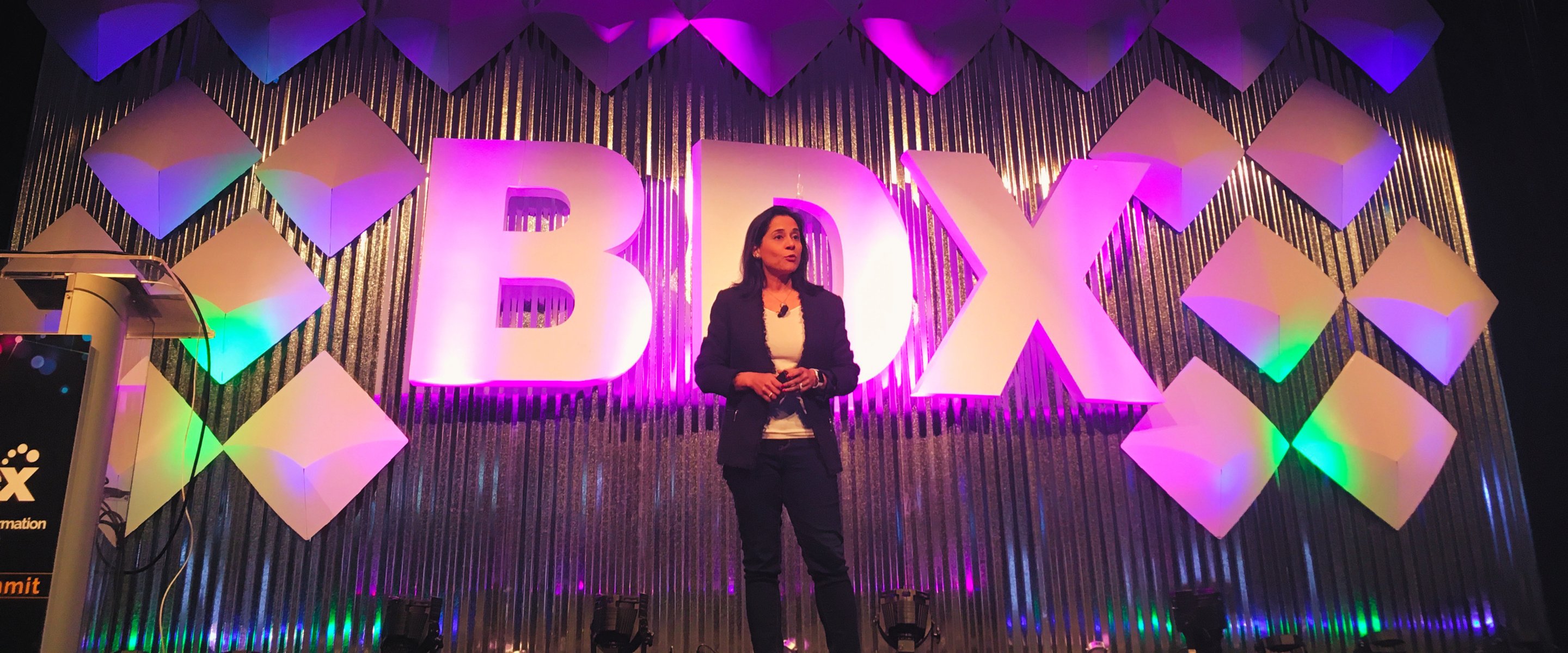 Nikki Barua delivering a keynote on stage at the BDX Summit