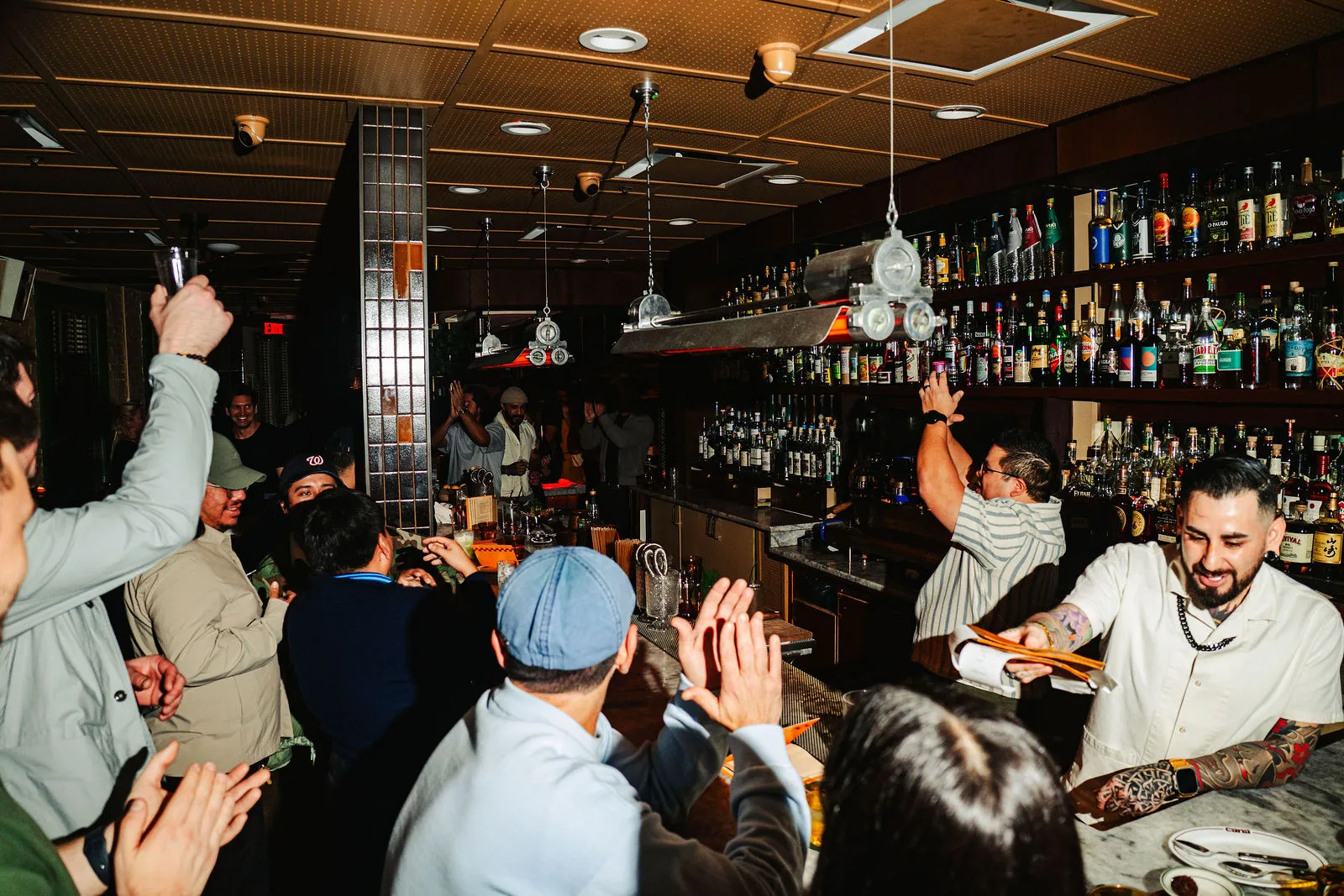 A packed crowd gathered around CANA's bar