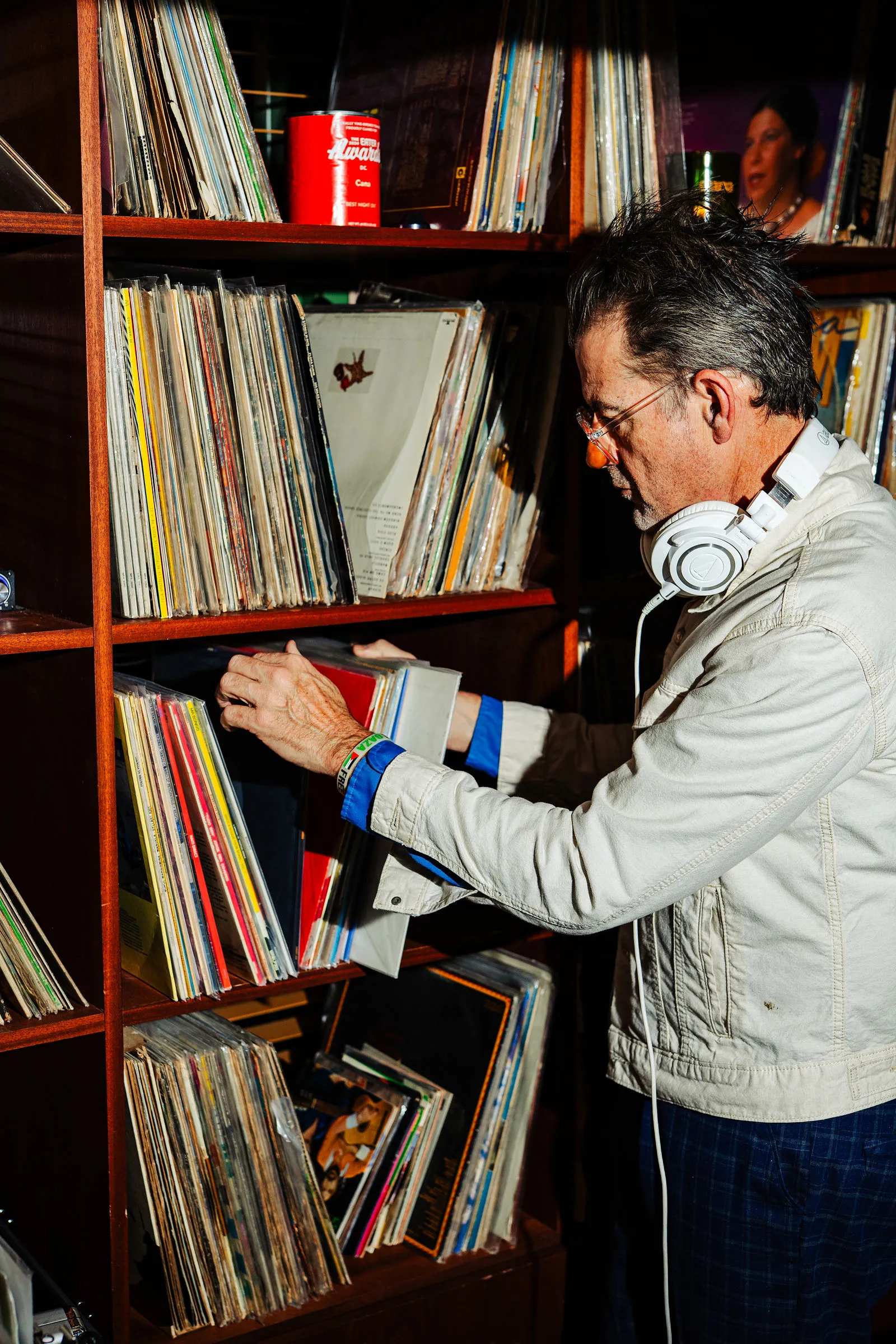 A selector working the turntables beside CANA's dining room