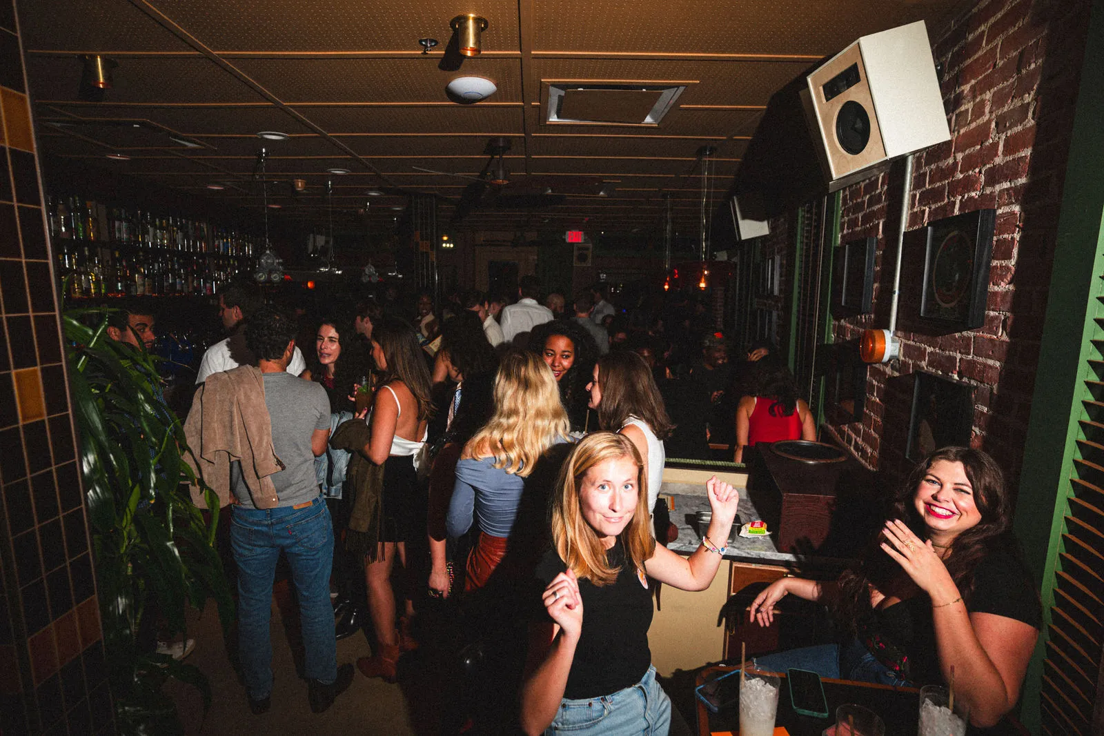 Guests standing and dancing through CANA during a late-night set