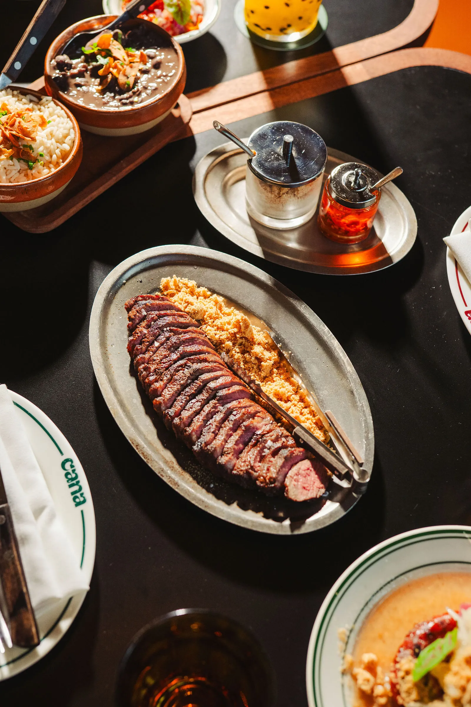 A CANA table filled with shared dinner plates and drinks
