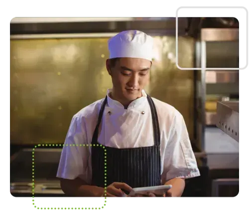 Chef using Safe Food Pro in kitchen on tablet