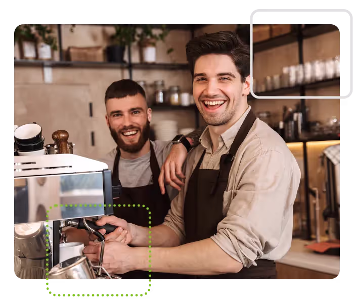 Two baristas making coffee in a cafe