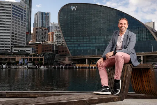 Richard Millar sitting in front of W Hotels Sydney