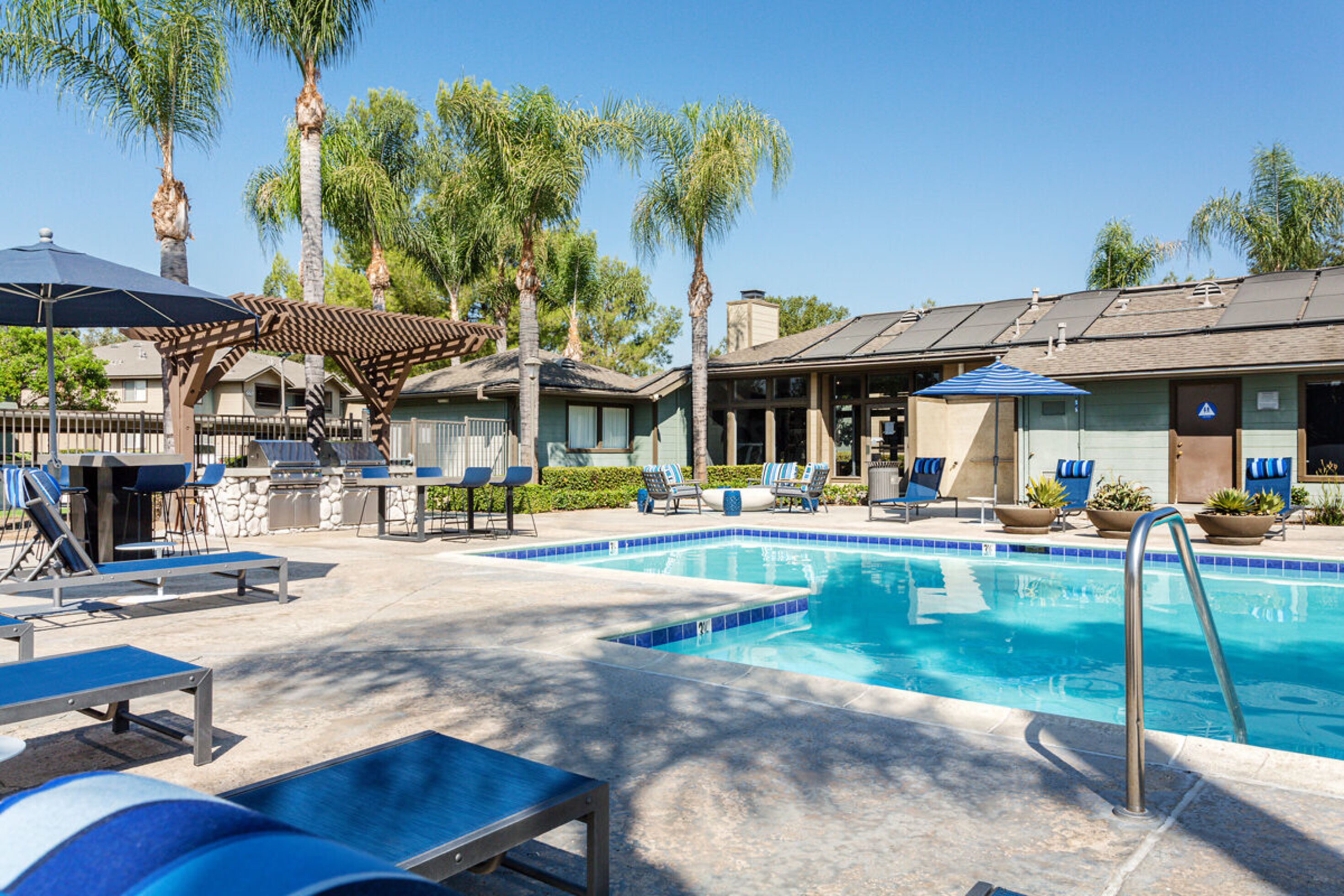Pool with lounge chairs surrounding on the deck
