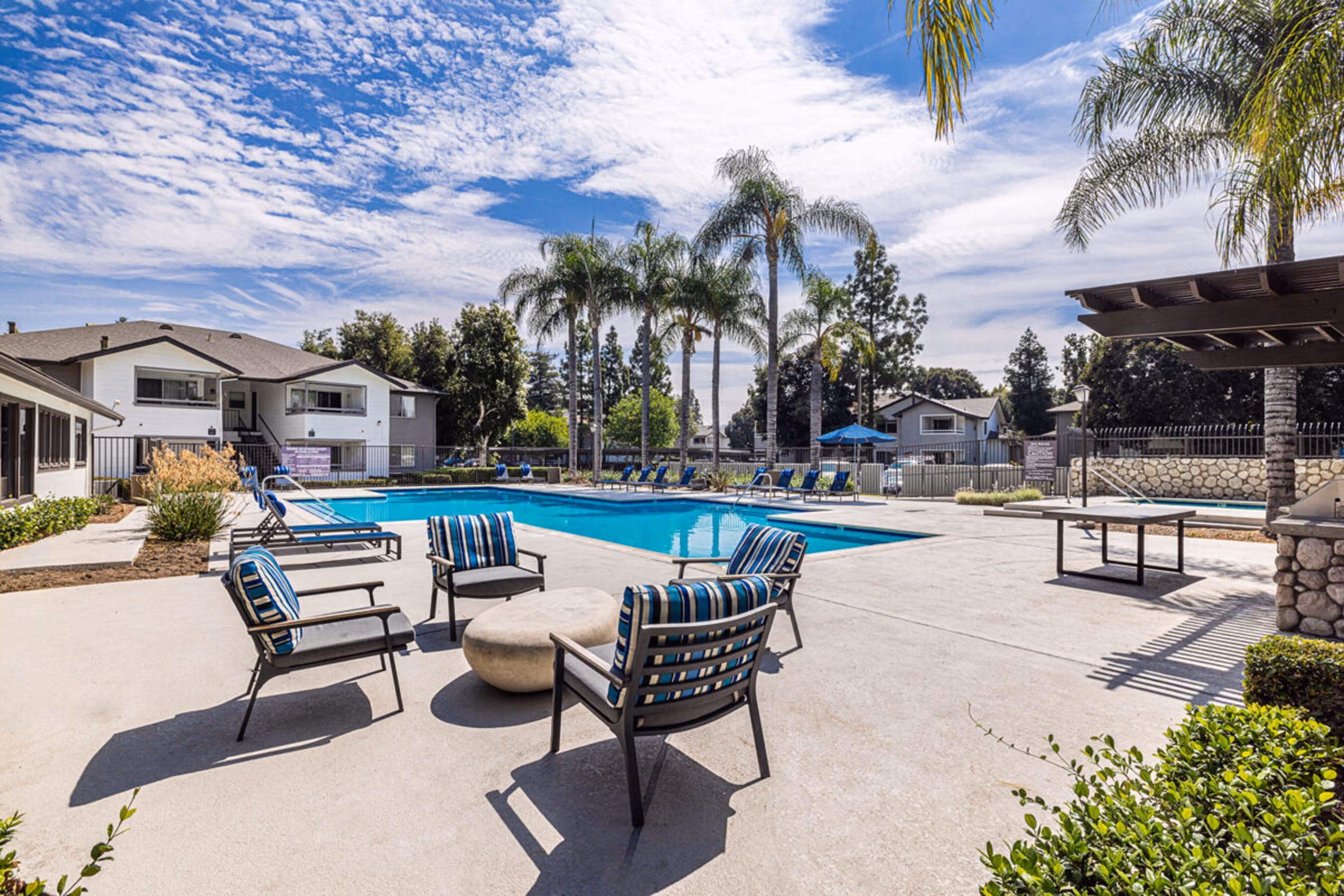 Pool with lounge chairs surrounding on the deck
