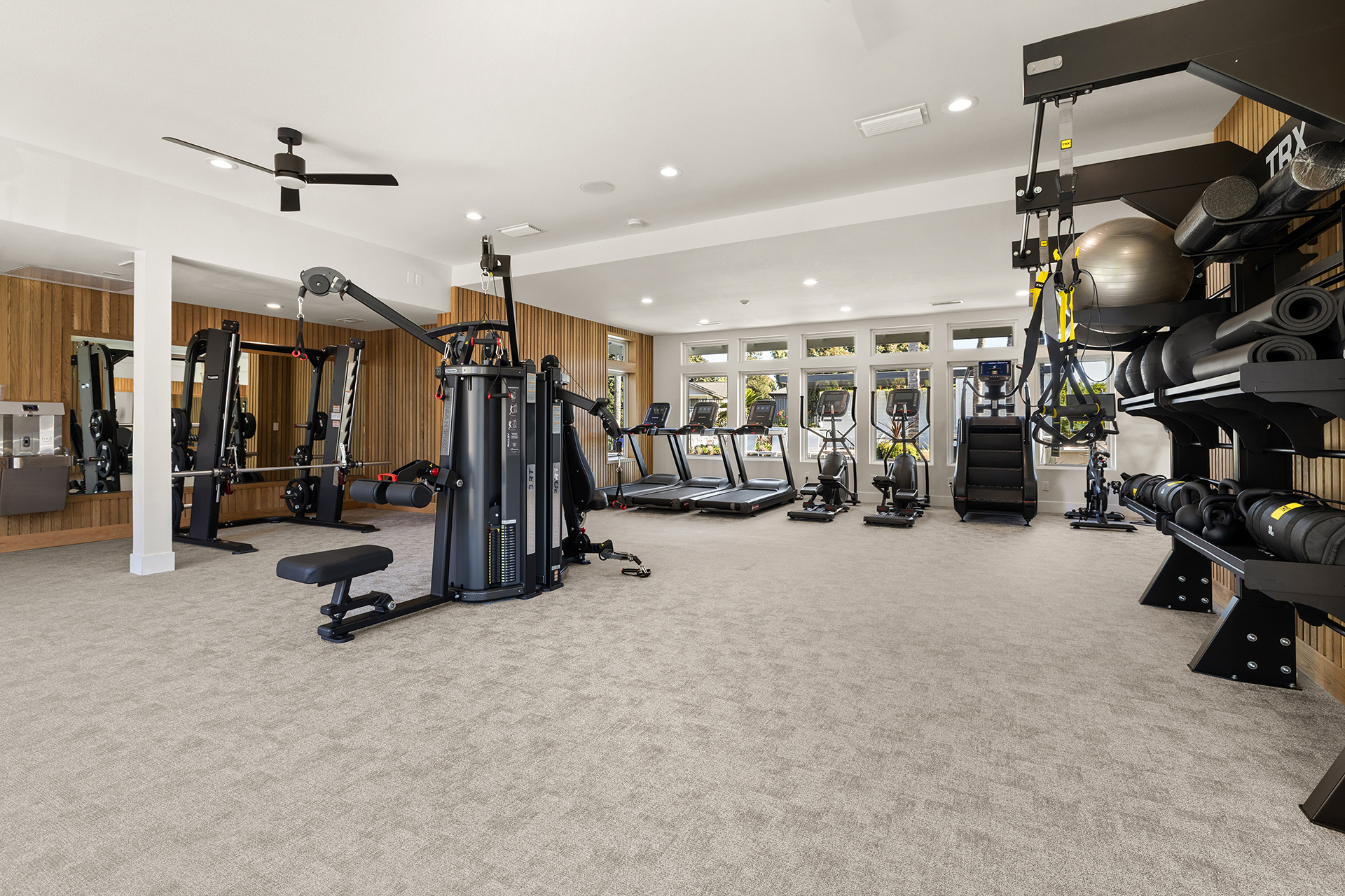 Gym with weight rack featuring dumbbells and yoga ball