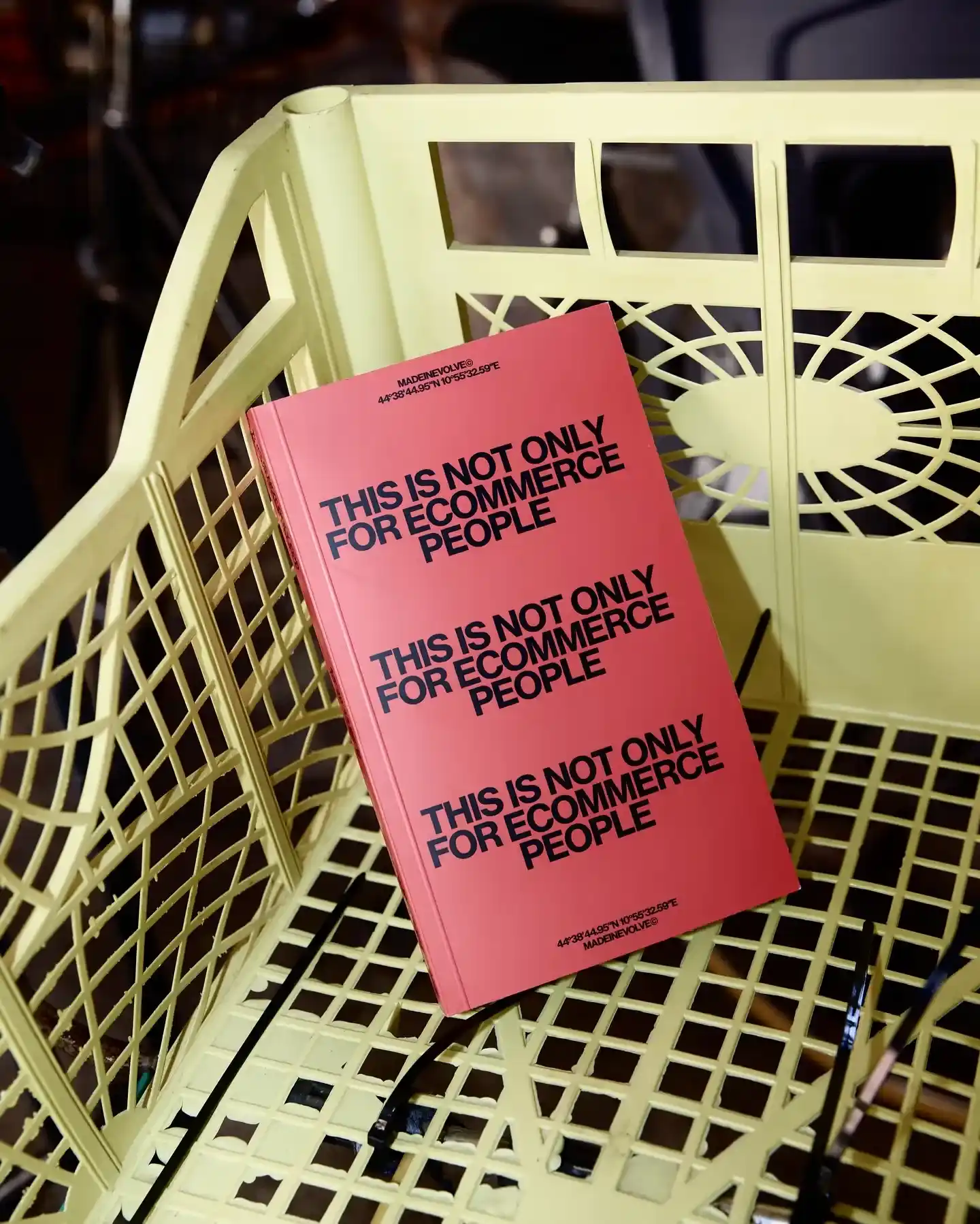 Red book with repeated text 'This is not only for ecommerce people' placed on a beige plastic chair.