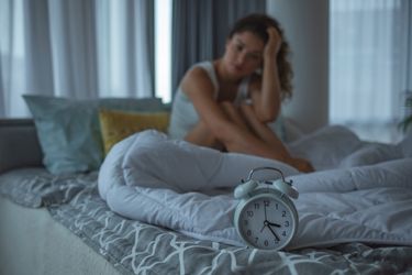 Woman in bed with sleeping problems