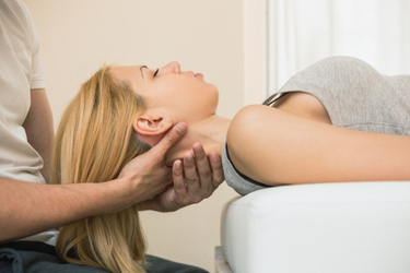 Chiropractor helping with the neck