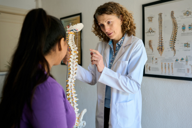Chiropractor talking to her patient
