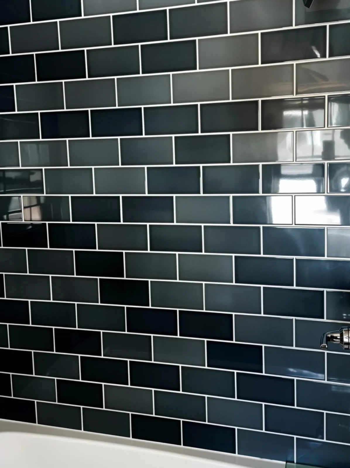 Deep teal glazed subway tile laid in a running bond with tight lines, installed by Euphoric Tile & Design in coastal Maine