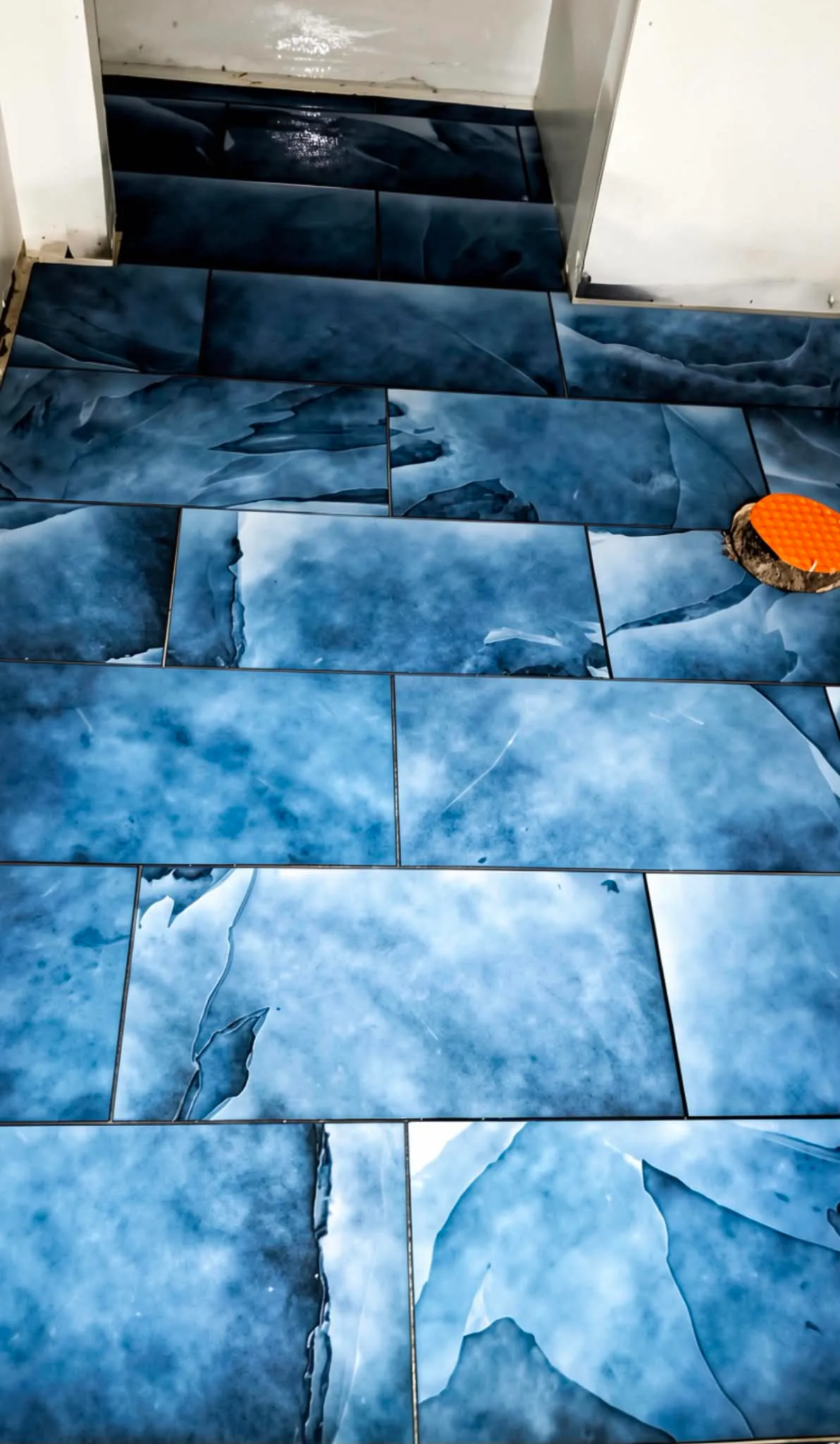 Blue agate-look large format tile floor, book-matched across the room, installed by Euphoric Tile & Design in coastal Maine