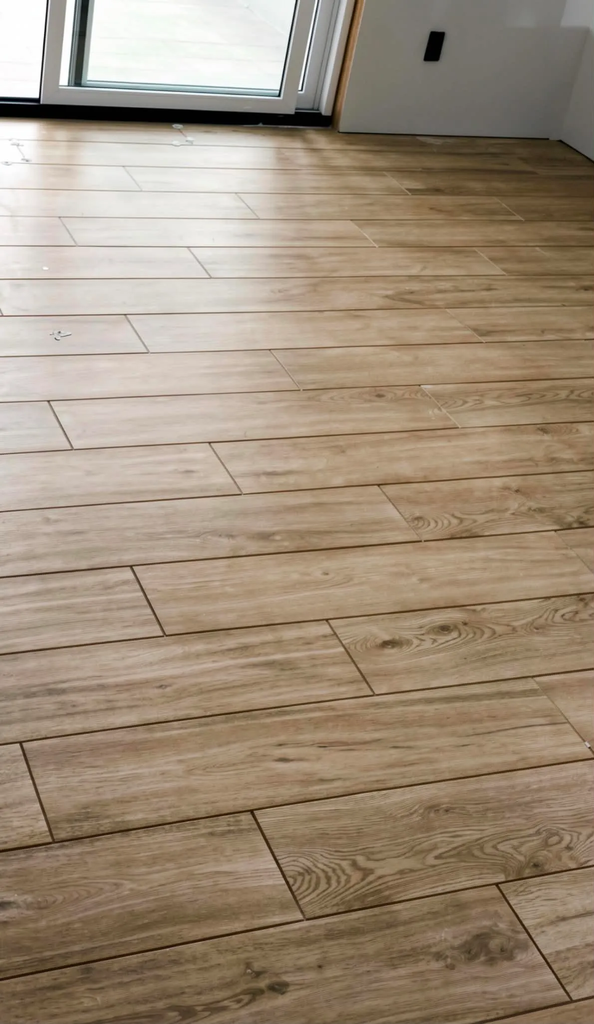 Wood-look plank tile floor with tight, even joints, installed by Euphoric Tile & Design in coastal Maine