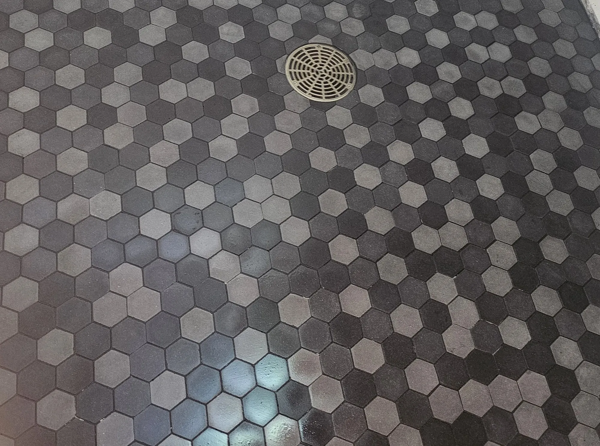 Hexagonal mosaic tile floor with an inlaid compass medallion, installed by Euphoric Tile & Design in coastal Maine