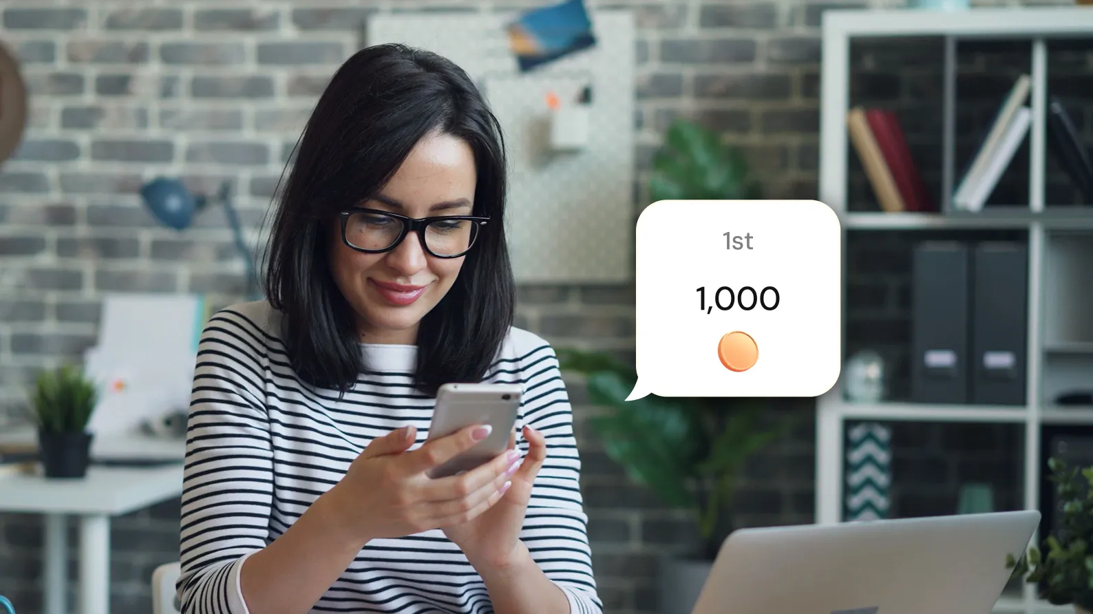 Woman with glasses smiling at her phone with a speech bubble showing 1,000 and 1st place.