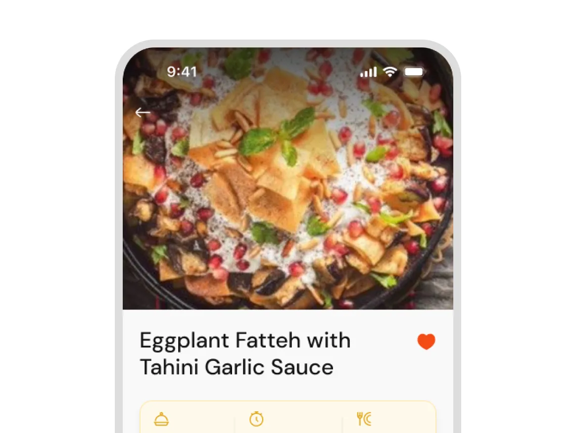Eggplant fatteh dish with tahini garlic sauce, garnished with pomegranate seeds and mint leaves.